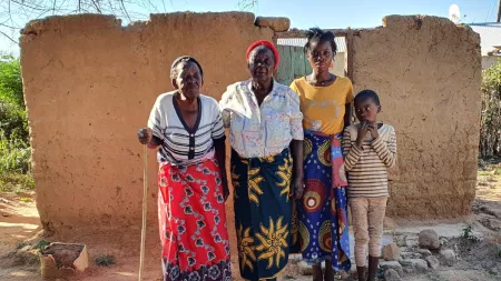 Zambia_Older ladies standing with younger children in front of destroyed home with no roof