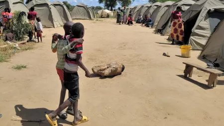 Zambia_Young boys hugging while they walk in displacement camp