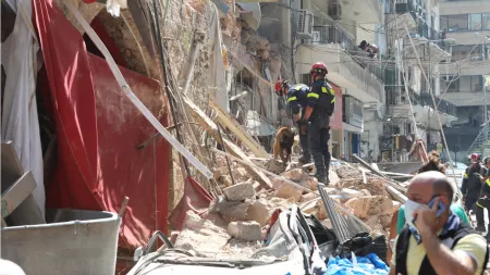 Lebanon_Rescueres standing on rubble with german sheperd