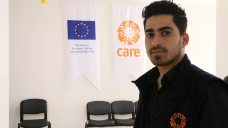 Turkiye_CARE coach in black jacket standing in front of CARE and EU banners