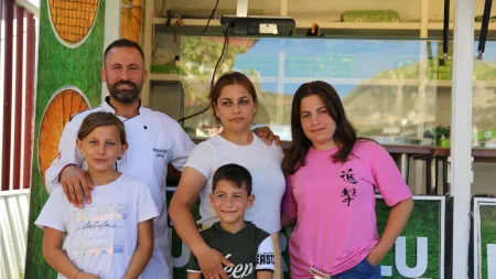 Turkiye_Family standing in front of food truck hugging