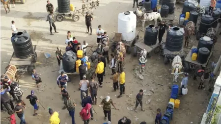 People with donkeys and water galons