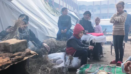 Palestinians in a makeshift camp for displaced people in Rafah city, near Gaza's border with Egypt, use clay ovens for cooking due to the absence of cooking gas and electricity.