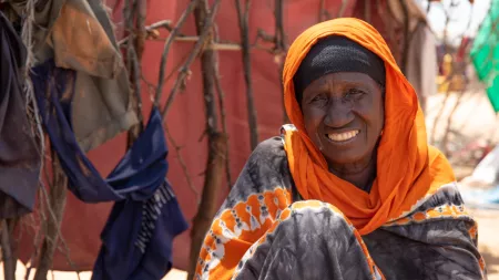 Woman sitting on the floor smiling at camera