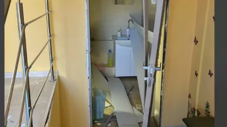 Glass, rubble, misplaced door of bathroom