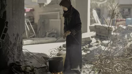 woman cooking woodfire