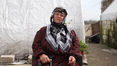woman sitting and holding cane