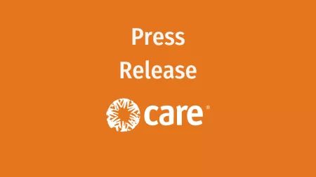 Press release text and CARE's logo over orange background
