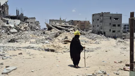 person walking amid rubble