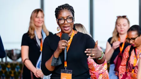 CARE staff speaking during leadership event.