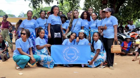 Members of a VSLA in Madagascar stand in unity.