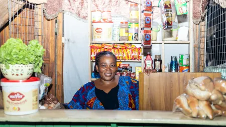 Akossiwa, a farmer and foodseller from Togo, in front of her shop.