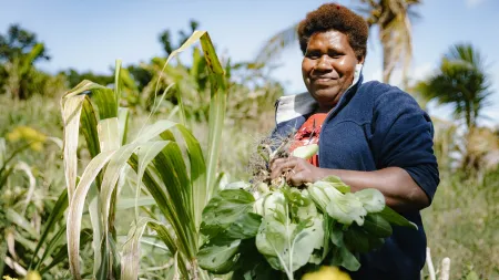 Diana, 36 years old, from Lamlu, Tanna harvests bok choy from her garden.