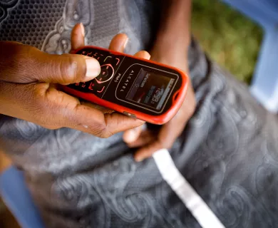 Person holding mobile phone in Kenya