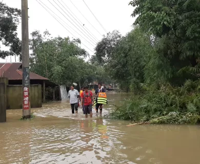 People walk in flooded area in Bangladesh