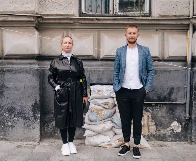 Maria and Bohdan standing side by side on a street