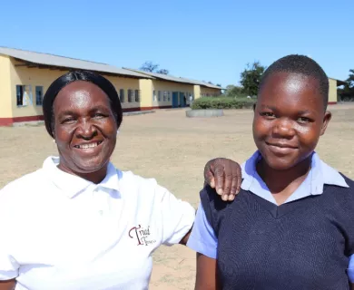 Zimbabwean teacher and school girl in school yard