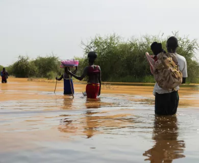 People walking in flooded road in South Sudan
