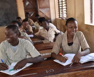 Benin_School students sitting at desks writing