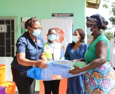 Woman handing emergency aid to another woman
