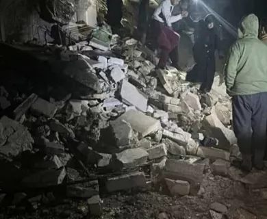 People climbing down rubble