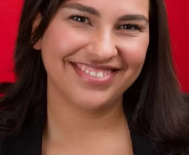 Headshot of woman with long straight dark hair smiling to the camera