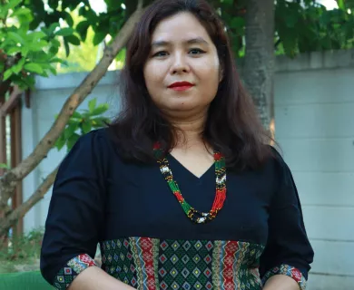 Woman with half smile, long dark straight hair