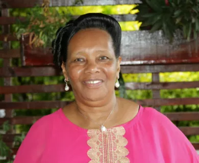 Woman with black hair pulled back smiling to the camera