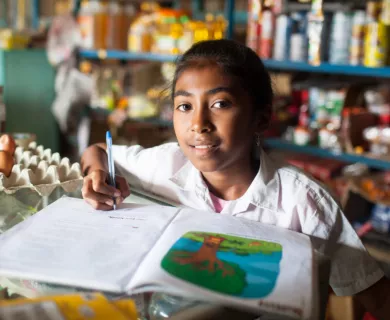 Timor-Leste_Girl sitting in small shop doing homework