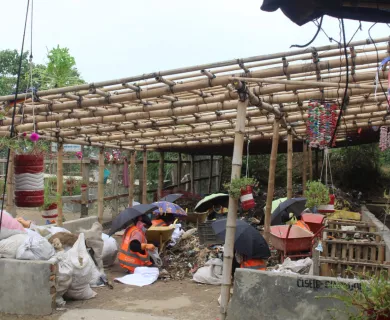 Myanmar-Bangladesh_People sitting under bamboo structure after cyclone mocha