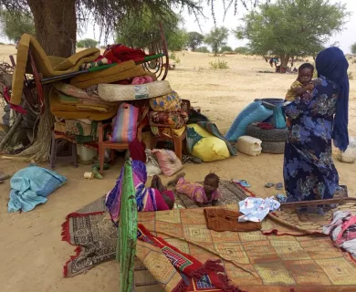 Woman holding baby in IDP camp in Chad