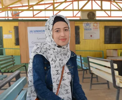 Jordan_Woman in chanel hijab sitting on blue bench
