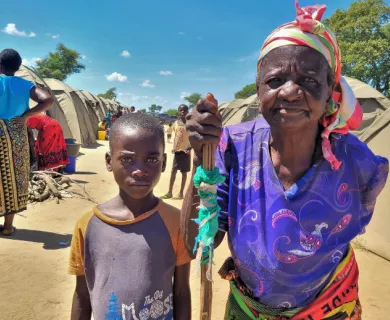 Zambia_Old lady wearing purple blouse standing next to grandson