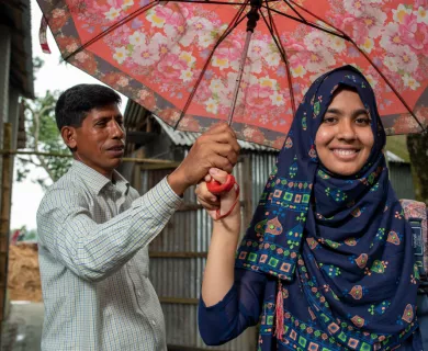 Bangladesh_Father holding umbrella over daughter's head