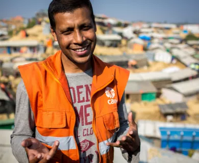 Bangladesh_Man smiling wearing orange CARE vest