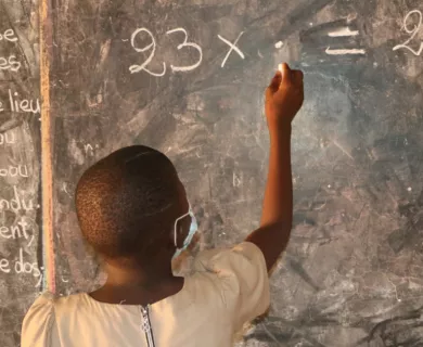 Benin_School girl writing on chalk board