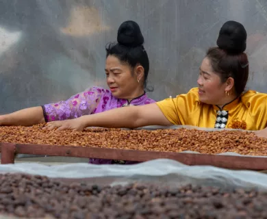 Vietnam_Women sieving coffee beads on machine_Laura NoelCARE