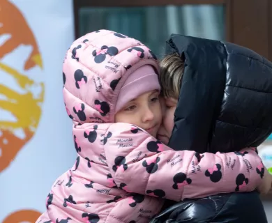 Poland_Woman with black puffer with daughter hugging in pink puffer