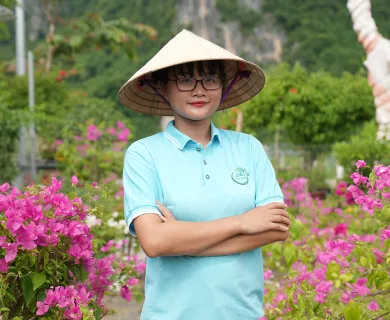Woman with crossed arms standing in garden