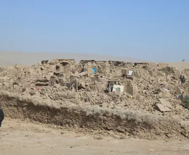 person passing by rubble