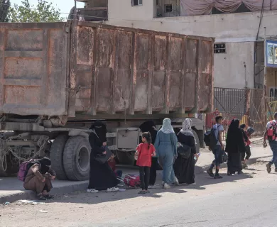 People walking in front of truck in Gaza