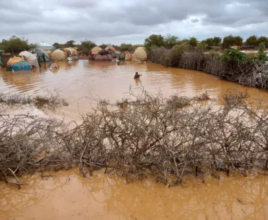 One person half submerged in flooded area