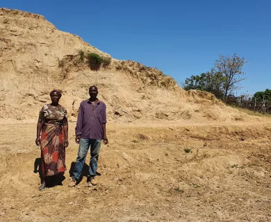 Man and woman standing muddy area