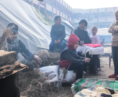 Palestinians in a makeshift camp for displaced people in Rafah city, near Gaza's border with Egypt, use clay ovens for cooking due to the absence of cooking gas and electricity.