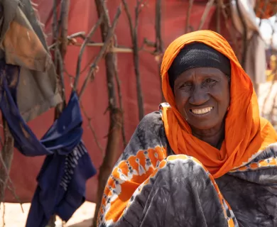 Woman sitting on the floor smiling at camera