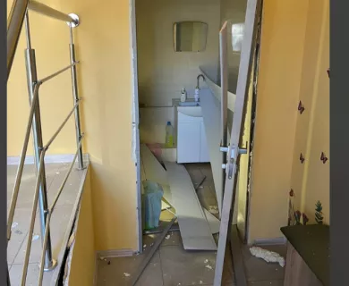 Glass, rubble, misplaced door of bathroom