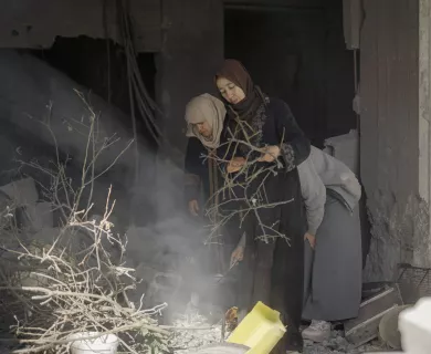 women looking down amid rubble