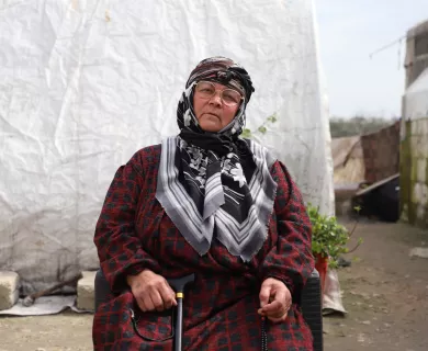 woman sitting and holding cane