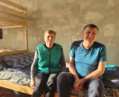 Elderly woman and man sitting in shelter