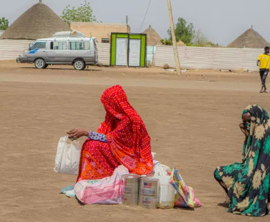 IDPs wait for transport after a food distribution at Un Gargor, Kassala, where thousands of displaced people from Sinnar and Sinjhah have settled following an escalation in violence.